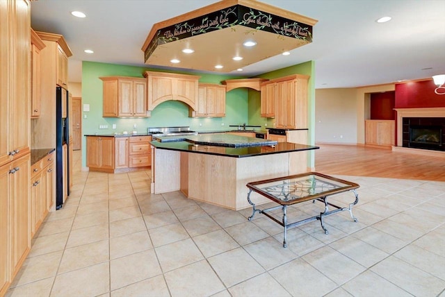 457 Union Rd, Brooklyn, WI 53521 - kitchen featuring light tile patterned floors, light brown cabinetry, and custom exhaust hood