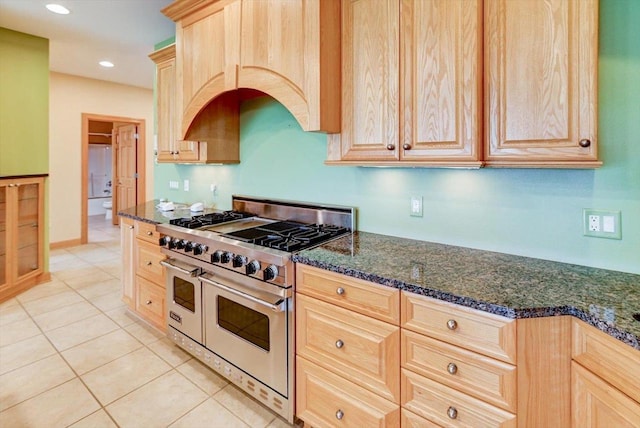 457 Union Rd, Brooklyn, WI 53521 - kitchen with dark stone counters, light tile patterned flooring, double oven range, and light brown cabinets