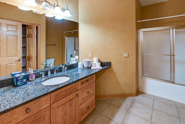 457 Union Rd, Brooklyn, WI 53521 - bathroom with tile patterned floors, baseboards, bath / shower combo with glass door, and vanity