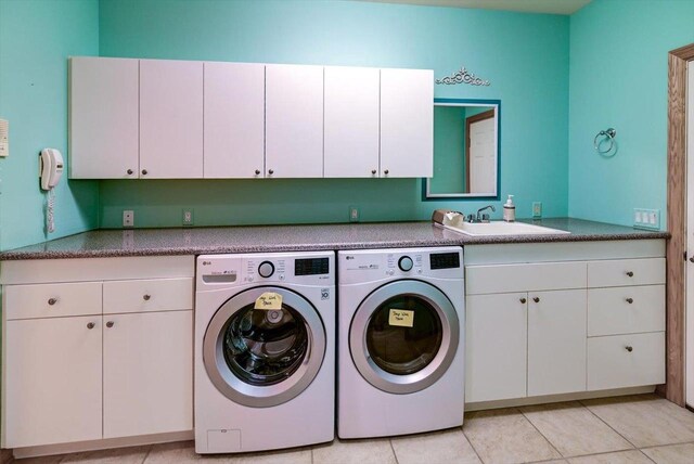 457 Union Rd, Brooklyn, WI 53521 - clothes washing area featuring a sink, light tile patterned floors, cabinet space, and washing machine and clothes dryer