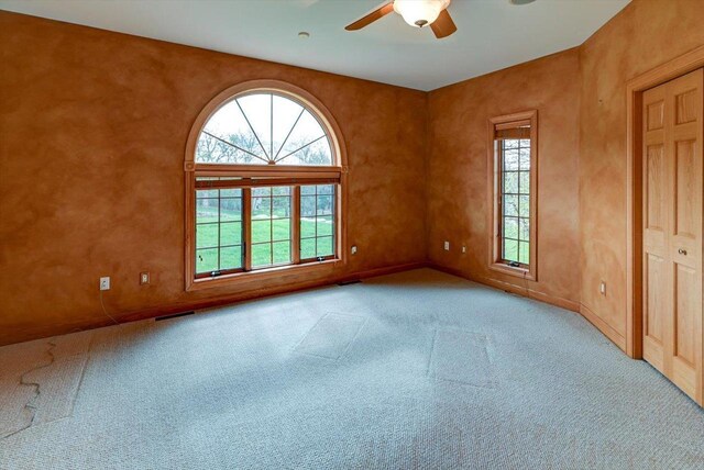 457 Union Rd, Brooklyn, WI 53521 - carpeted empty room featuring ceiling fan, visible vents, plenty of natural light, and baseboards
