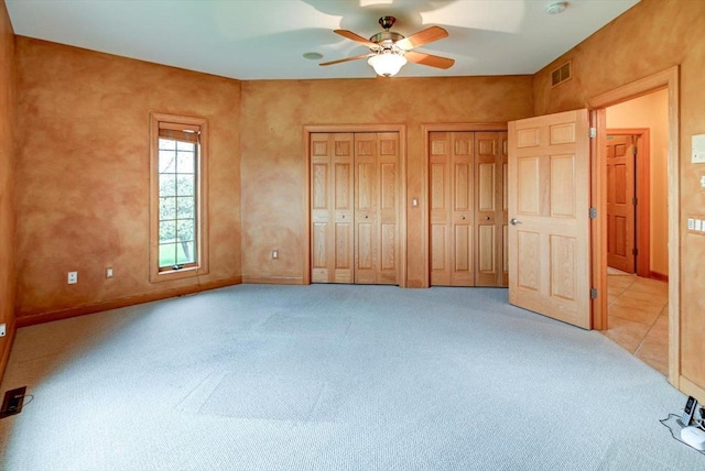 457 Union Rd, Brooklyn, WI 53521 - unfurnished bedroom with ceiling fan, visible vents, baseboards, multiple closets, and carpet