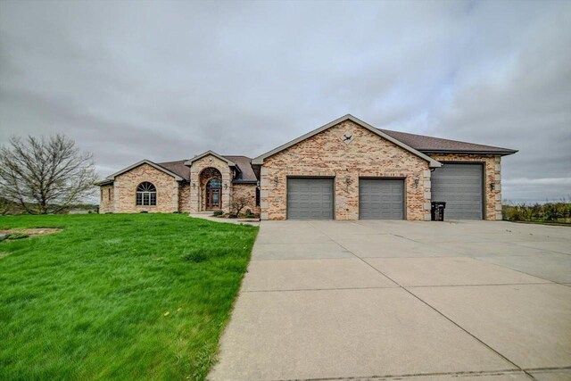 457 Union Rd, Brooklyn, WI 53521 - view of front of house with roof with shingles, brick siding, a front lawn, concrete driveway, and an attached garage