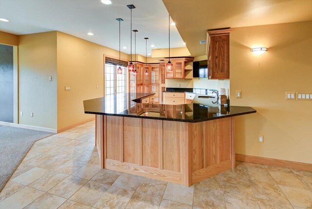 457 Union Rd, Brooklyn, WI 53521 - kitchen featuring open shelves, a peninsula, baseboards, a sink, and dark stone countertops