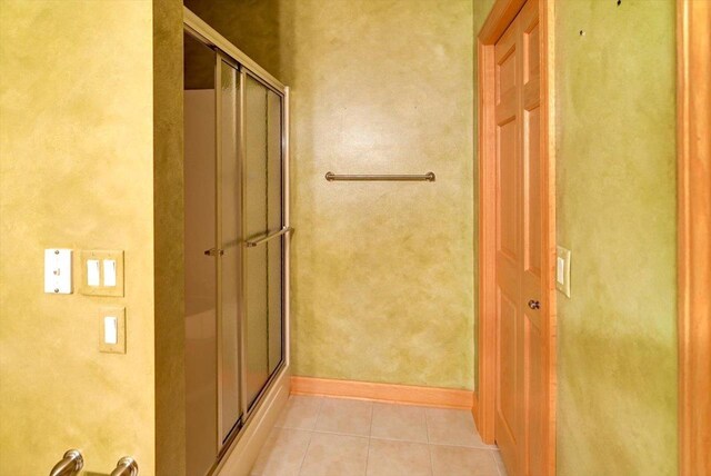 457 Union Rd, Brooklyn, WI 53521 - full bathroom featuring baseboards, tile patterned flooring, and a shower with shower door