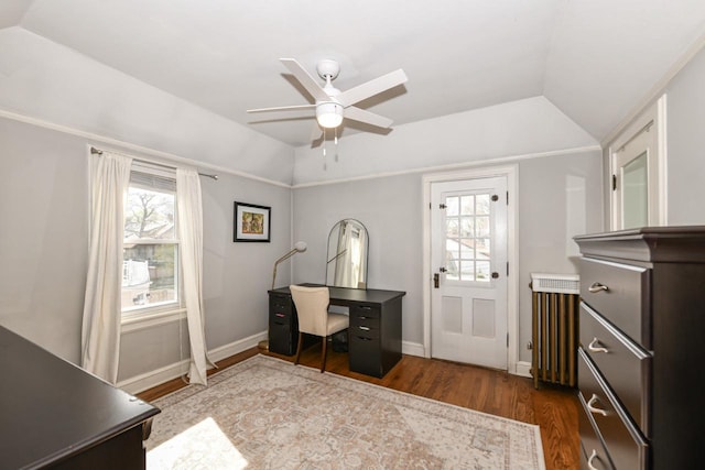 office featuring a ceiling fan, vaulted ceiling, dark wood-style floors, and radiator