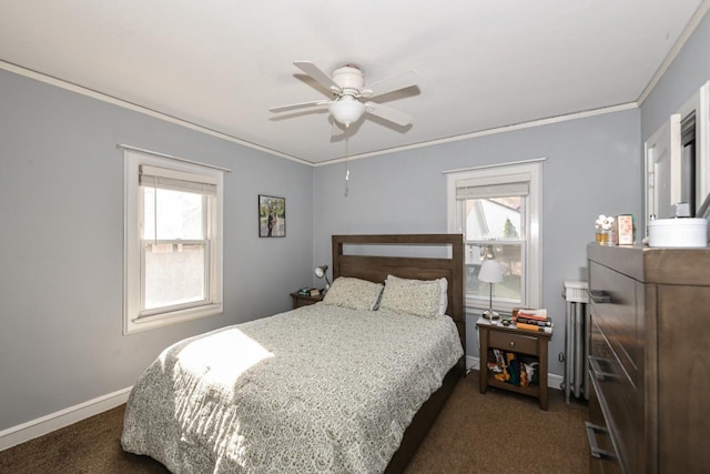 bedroom with ornamental molding, multiple windows, and dark carpet