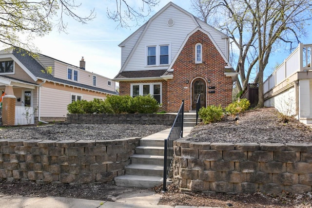 colonial inspired home with brick siding
