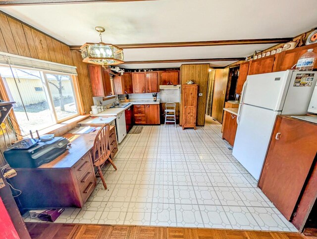 W7150 Maple Ridge Ln, Phillips, WI 54555 - kitchen with light floors, light countertops, brown cabinets, a sink, and a notable chandelier