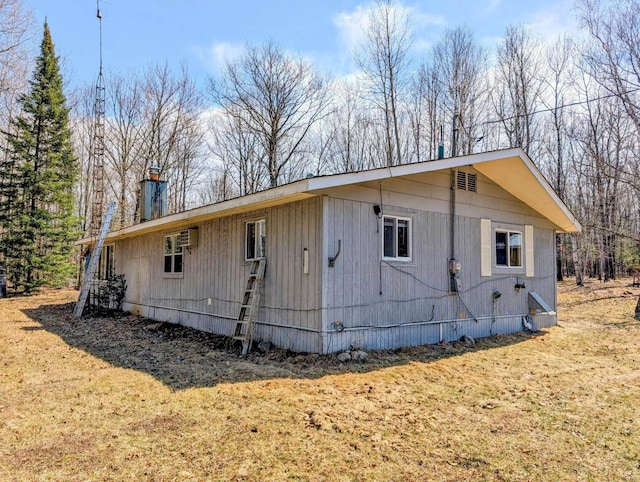 W7150 Maple Ridge Ln, Phillips, WI 54555 - view of side of home with a lawn and a chimney