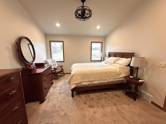 bedroom featuring visible vents, lofted ceiling, light carpet, recessed lighting, and a chandelier