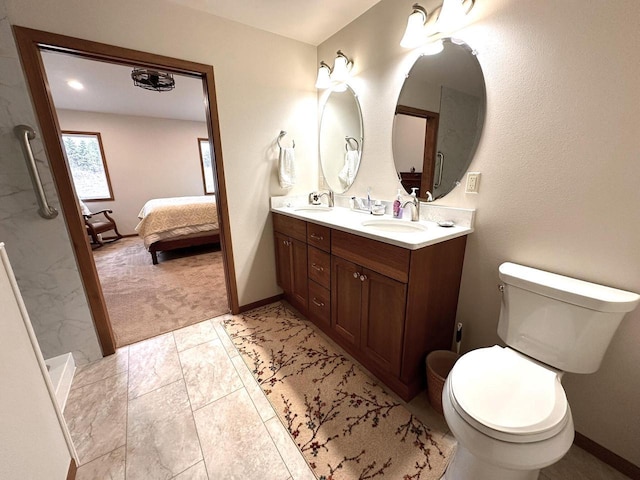 ensuite bathroom with double vanity, a sink, ensuite bathroom, and toilet
