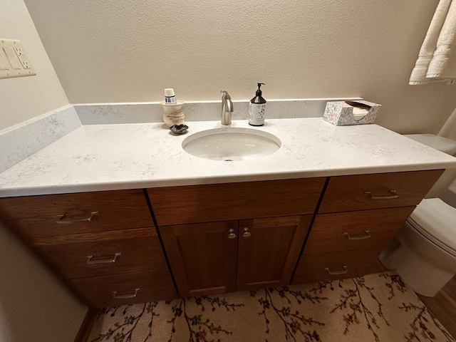 bathroom featuring toilet and vanity