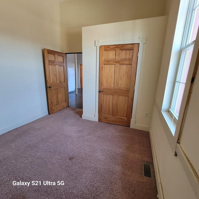 201-207 S Main St, Jefferson, WI 53549 - unfurnished bedroom with baseboards, visible vents, and carpet