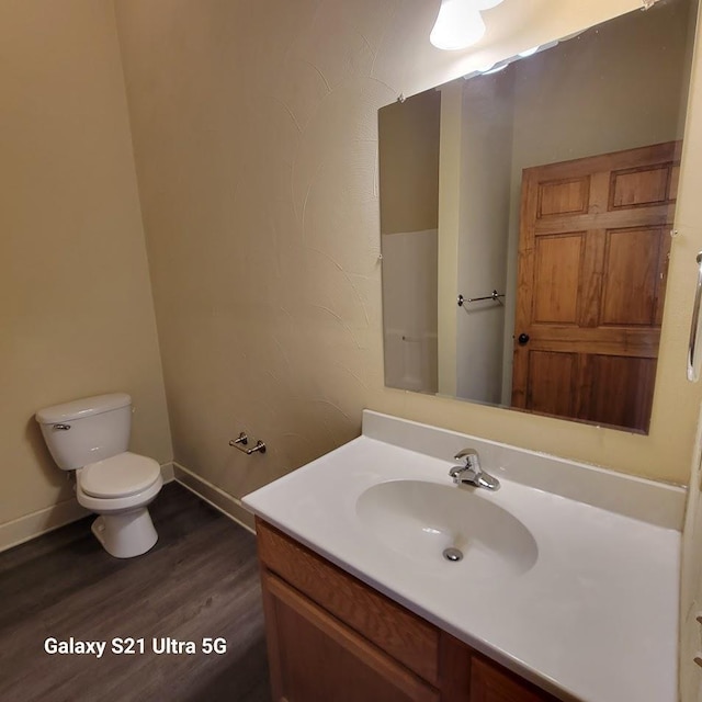 201-207 S Main St, Jefferson, WI 53549 - bathroom featuring toilet, wood finished floors, and vanity