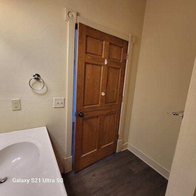 201-207 S Main St, Jefferson, WI 53549 - bathroom featuring baseboards, a sink, and wood finished floors