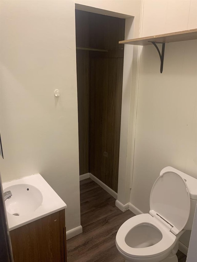 201-207 S Main St, Jefferson, WI 53549 - bathroom with toilet, baseboards, wood finished floors, and vanity