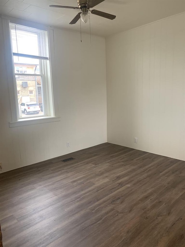201-207 S Main St, Jefferson, WI 53549 - empty room featuring a ceiling fan, dark wood finished floors, and visible vents