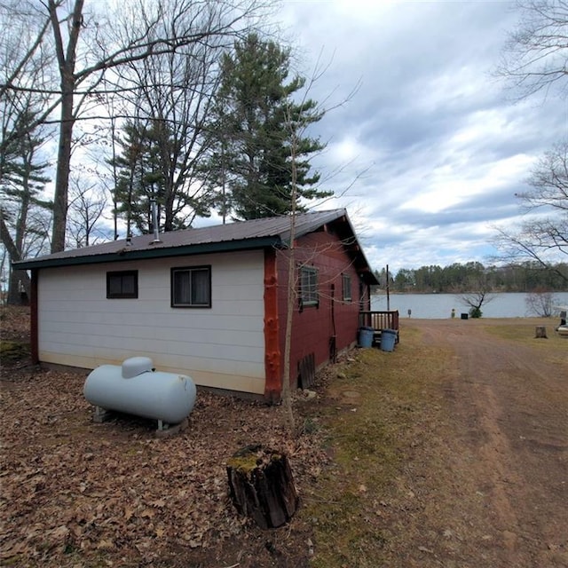 view of side of home with a water view