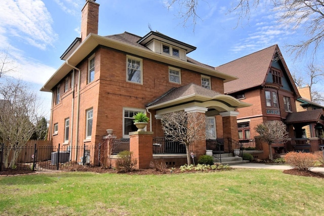 rear view of property with a lawn, brick siding, fence, and a chimney