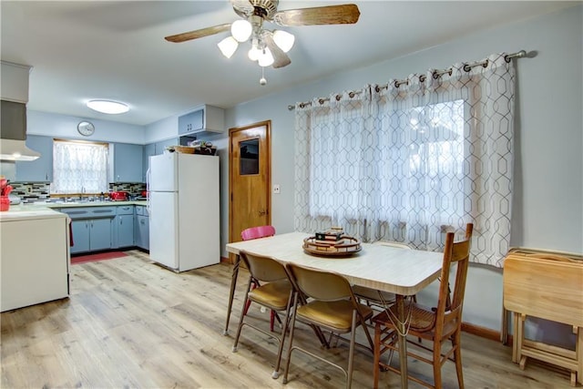 dining space featuring ceiling fan and light wood-type flooring