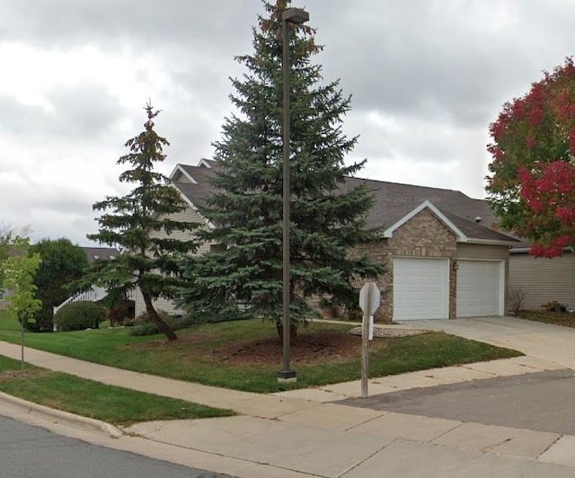 obstructed view of property with an attached garage and driveway