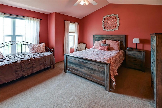 carpeted bedroom featuring multiple windows, a ceiling fan, and lofted ceiling