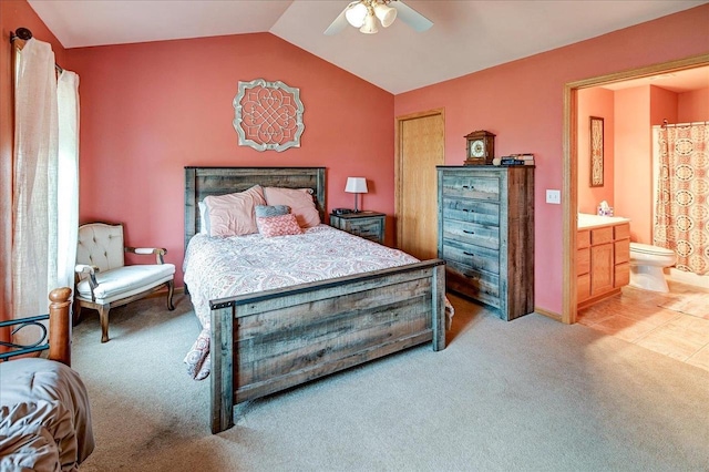 bedroom featuring ceiling fan, light carpet, connected bathroom, and lofted ceiling