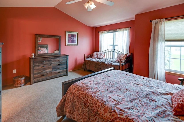 carpeted bedroom featuring a ceiling fan, lofted ceiling, and multiple windows