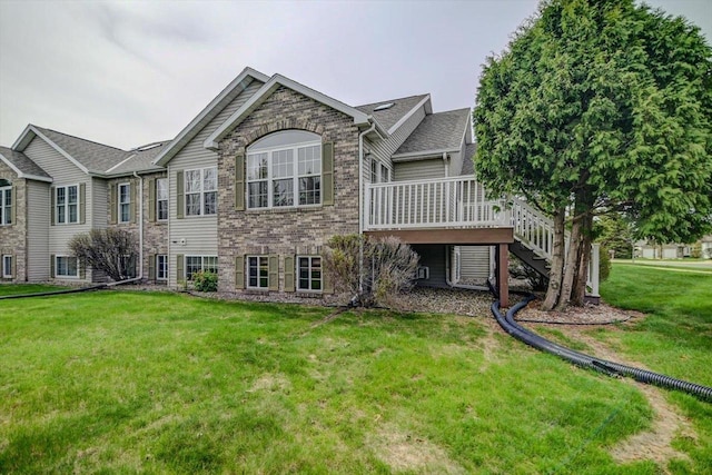 back of house featuring a yard, a deck, and stairs
