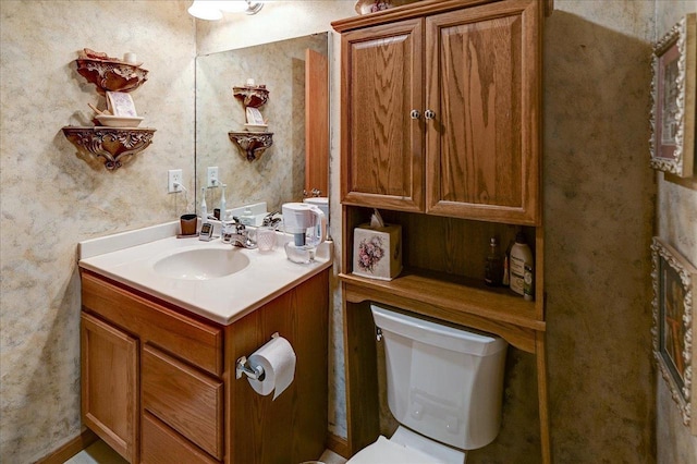 bathroom featuring toilet and vanity