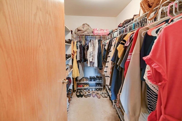 walk in closet featuring carpet