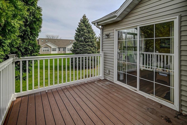 wooden deck featuring a lawn