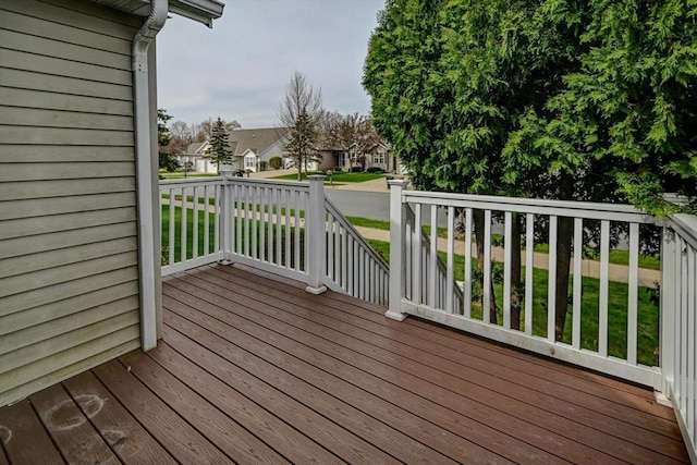 deck with a lawn and a residential view