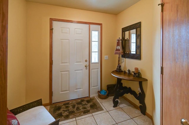 entrance foyer with baseboards and light tile patterned flooring