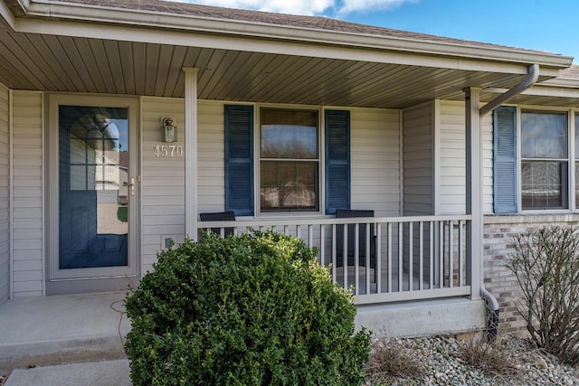 view of exterior entry with a porch
