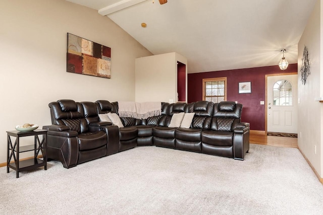 carpeted living room featuring a ceiling fan, baseboards, and vaulted ceiling with beams