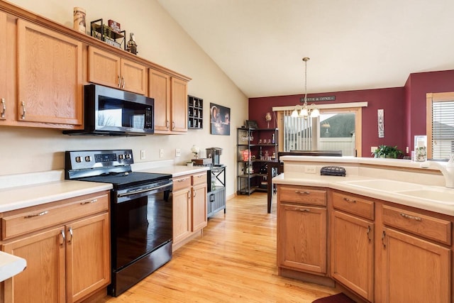 kitchen with an inviting chandelier, light wood-style floors, black range with electric stovetop, a sink, and vaulted ceiling