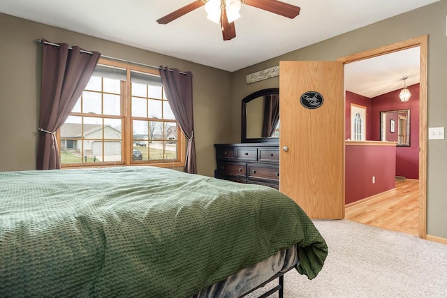 carpeted bedroom featuring baseboards, ceiling fan, and lofted ceiling