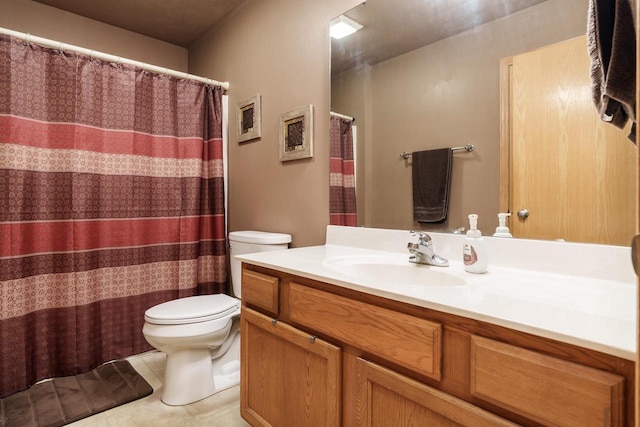 bathroom featuring vanity, tile patterned floors, and toilet