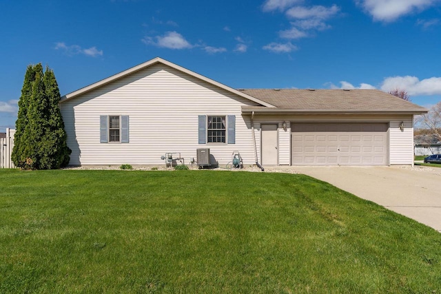 exterior space featuring a lawn, an attached garage, and concrete driveway