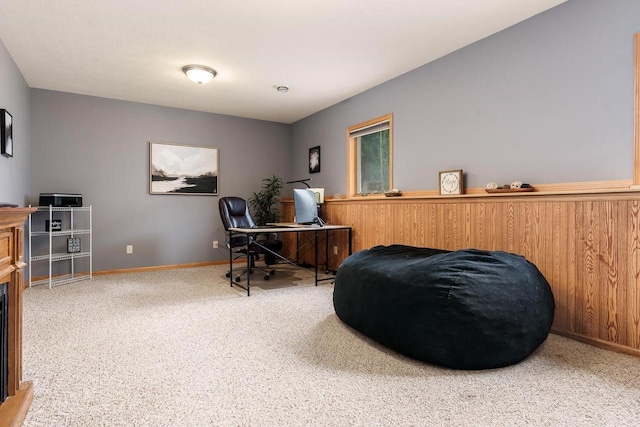 home office with carpet floors, baseboards, and a fireplace