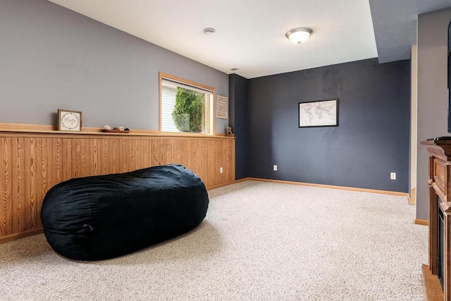 sitting room featuring carpet floors and baseboards