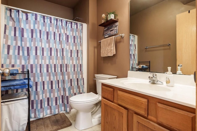 bathroom with tile patterned flooring, curtained shower, toilet, and vanity