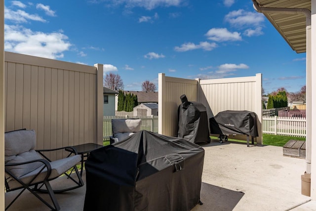 view of patio with grilling area, fence, and outdoor dining space