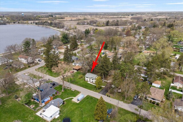 birds eye view of property featuring a water view and a residential view