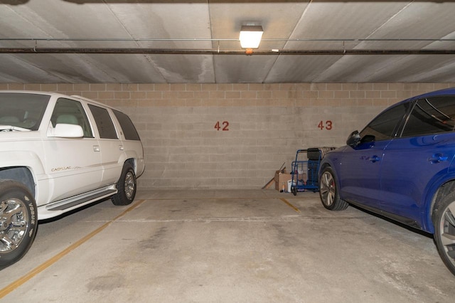 parking garage featuring concrete block wall