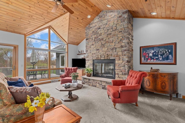 carpeted living area featuring wood ceiling, ceiling fan, a fireplace, and high vaulted ceiling
