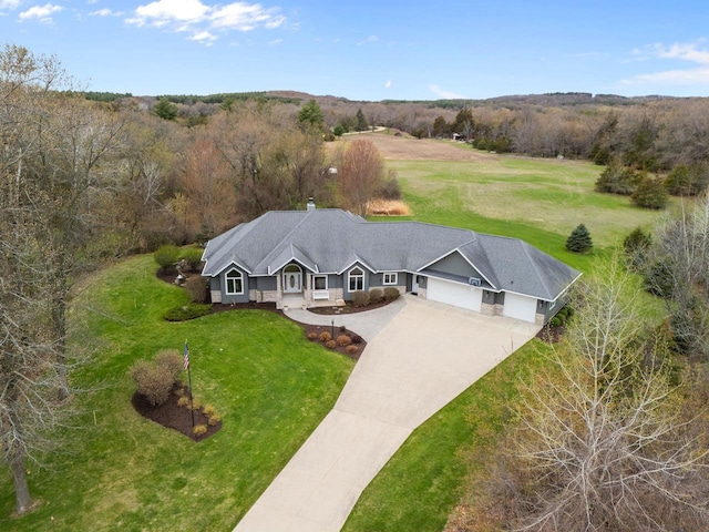birds eye view of property featuring a view of trees