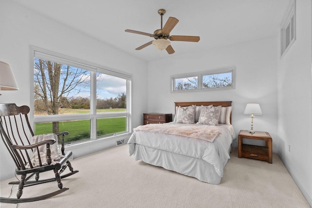 bedroom featuring carpet floors, visible vents, and multiple windows